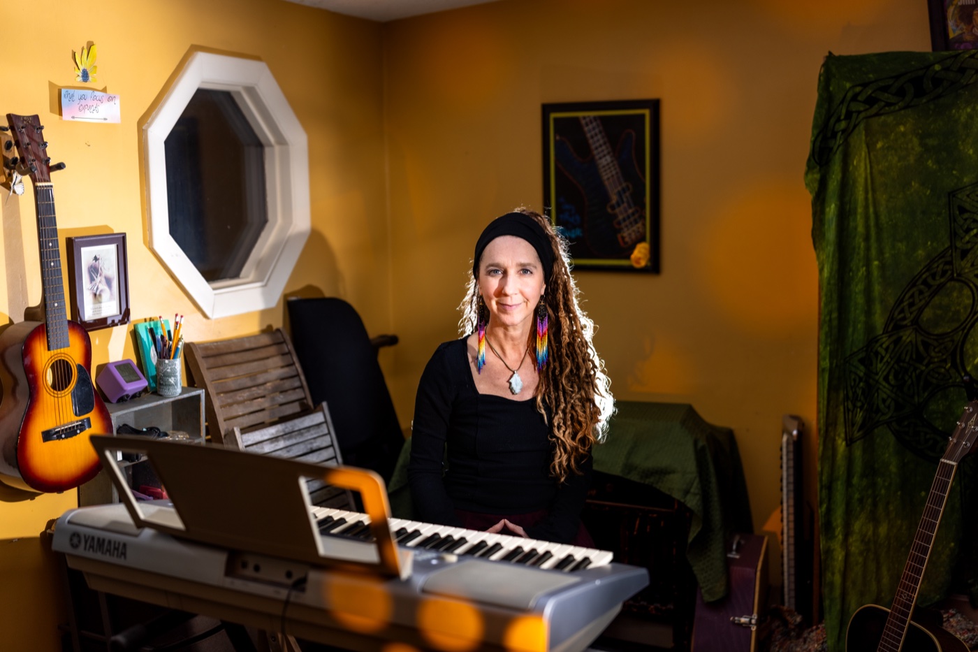 HannaH Ardenski looking toward the camera in her music studio