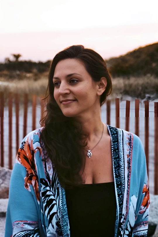 Sarah Korman outdoors near beach grass at sunset